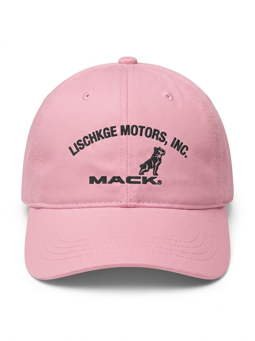 A light pink baseball cap featuring black embroidered text that reads 'LISCHKGE MOTORS, INC.' and 'MACK' with a dog logo, shown against a plain white background.